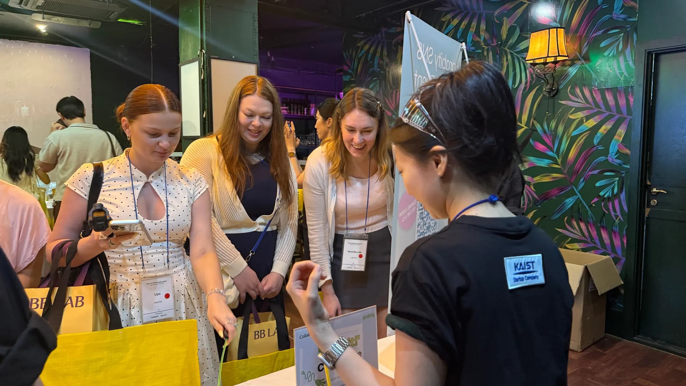 Global creators trying products at a CollabParty booth